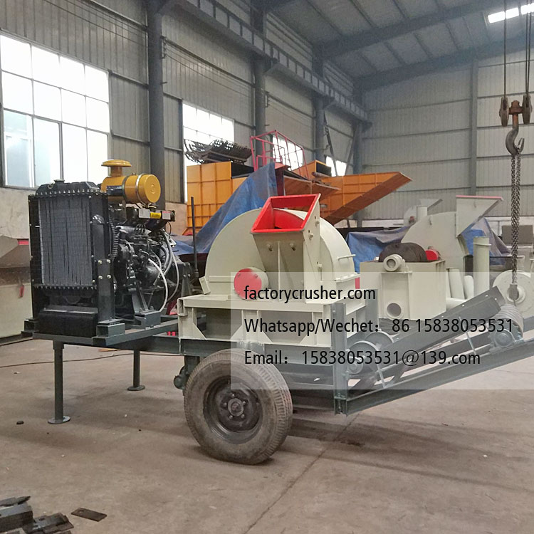 Large mobile diesel-powered wood chipper, wood shredder, with discharge conveyor belt.