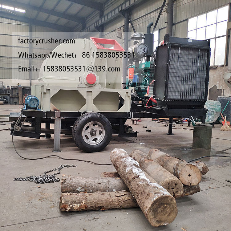 Large mobile diesel-powered wood chipper, wood shredder, with discharge conveyor belt.