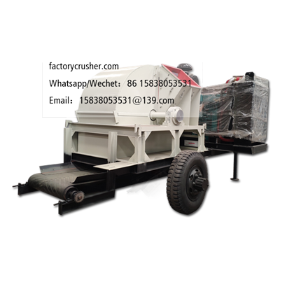 Large mobile diesel-powered wood chipper, wood shredder, with discharge conveyor belt.